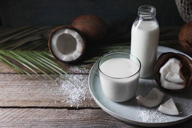 Composition with coconut milk on wooden table, space for text