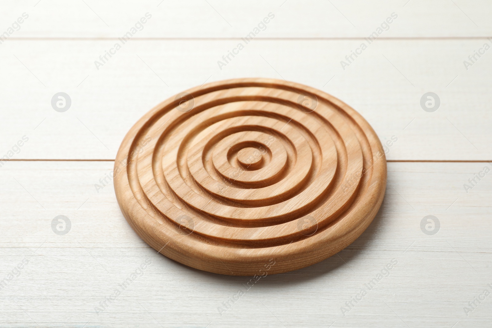Photo of Stylish wooden cup coaster on white table