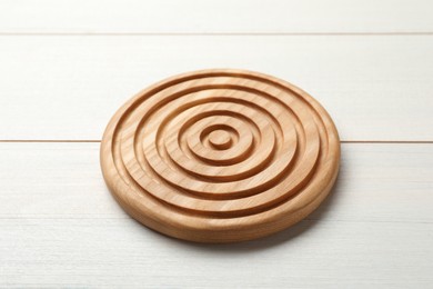 Photo of Stylish wooden cup coaster on white table