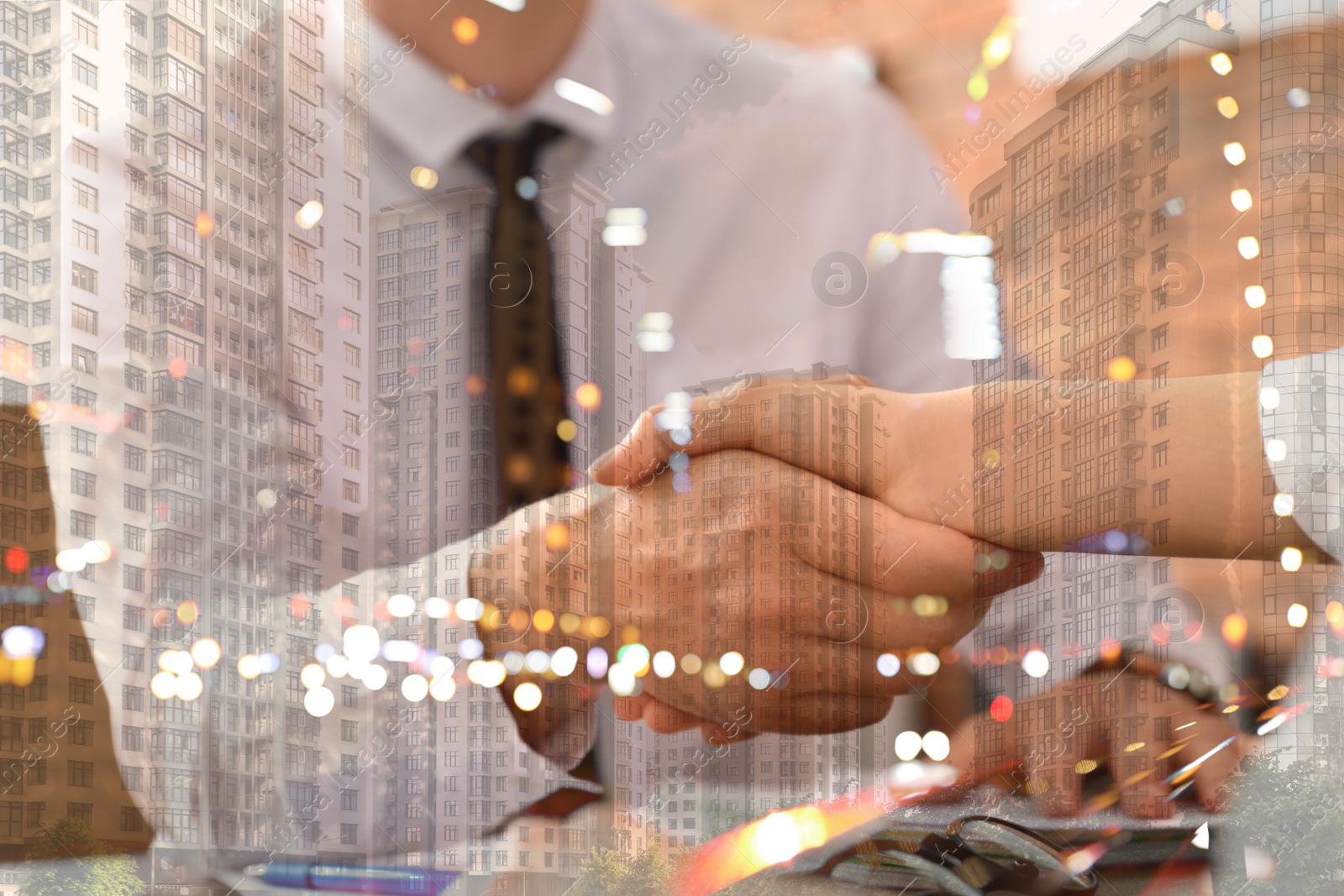 Image of Double exposure of partners shaking hands and night cityscape, closeup. Business corporation 