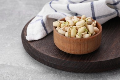 Photo of Sprouted kidney beans in bowl on light grey table, closeup. Space for text