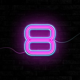 Image of Glowing neon number 8 sign on brick wall