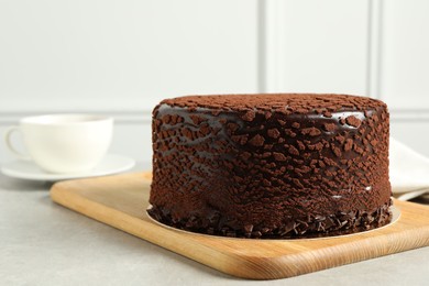 Photo of Delicious chocolate truffle cake on light grey table