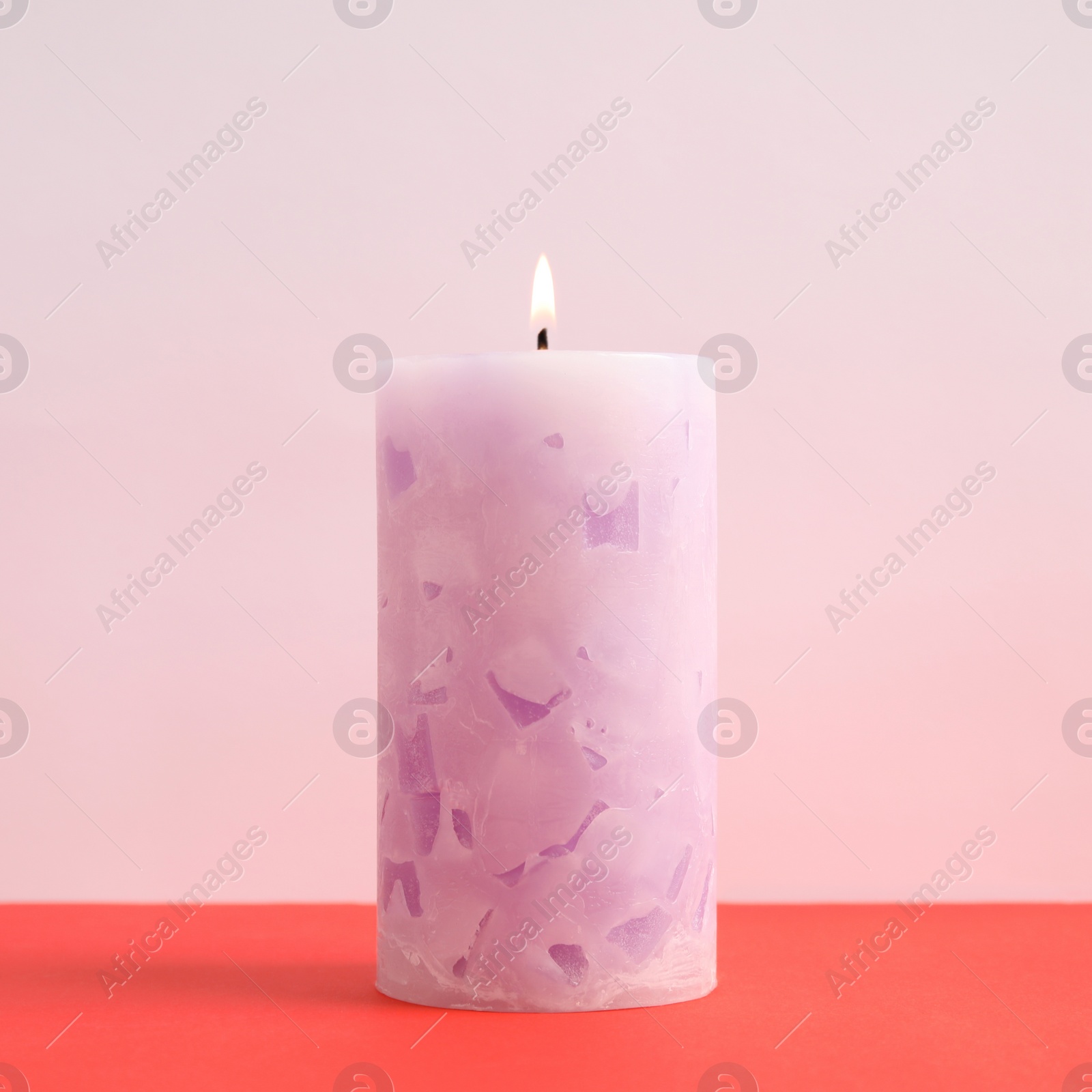 Photo of Alight scented wax candle on color background