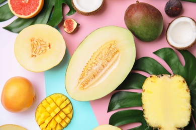 Flat lay composition with melon and other fruits on color background