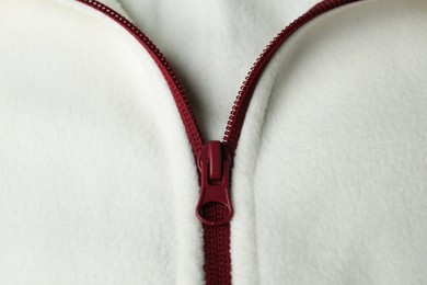 Photo of White woolen sweatshirt with zipper as background, top view