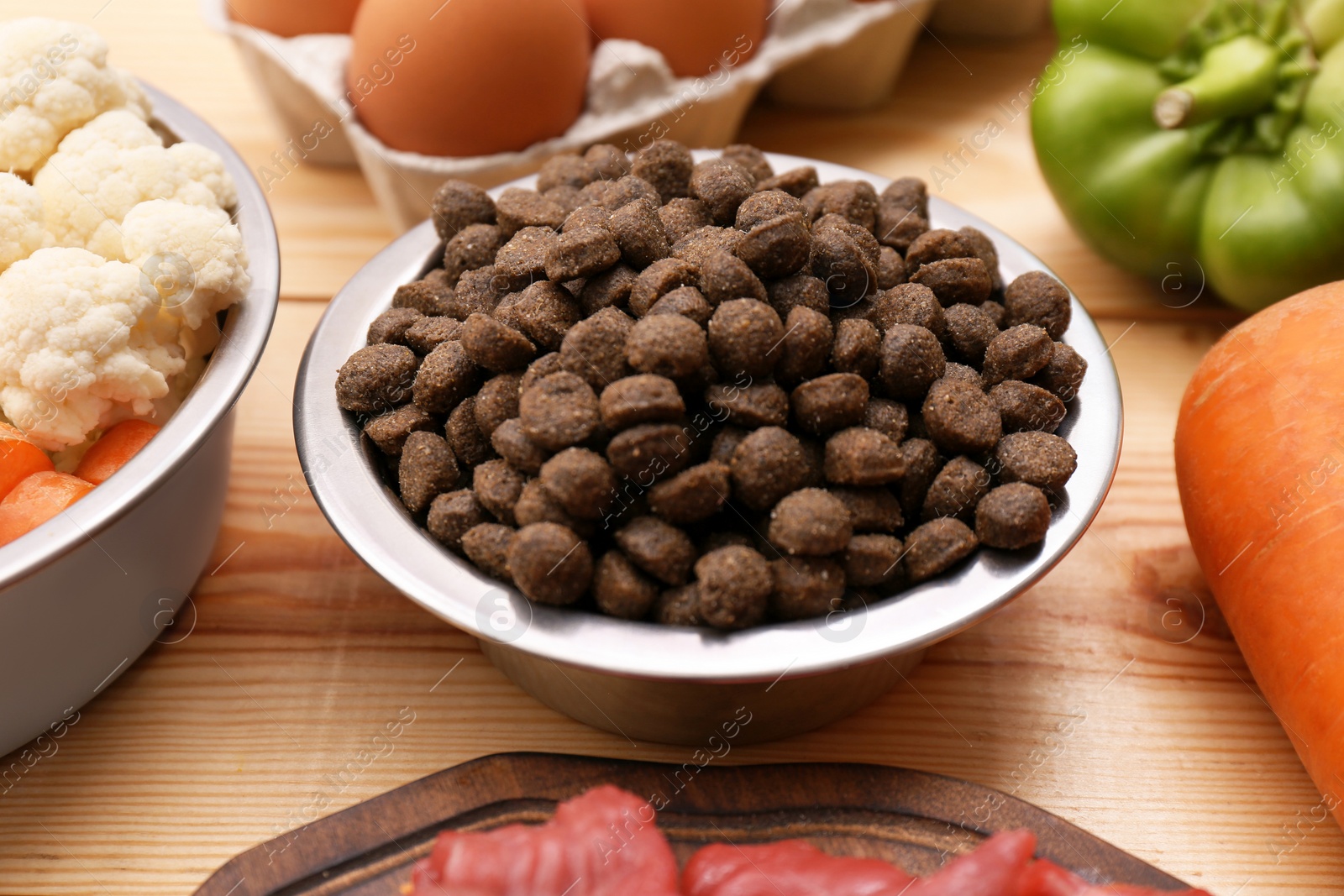 Photo of Composition with dry and natural dog food on table, closeup
