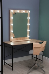 Beautiful mirror with lamps in modern makeup room