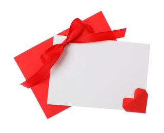 Photo of Blank card, envelope and red decorative heart on white background, top view. Valentine's Day celebration