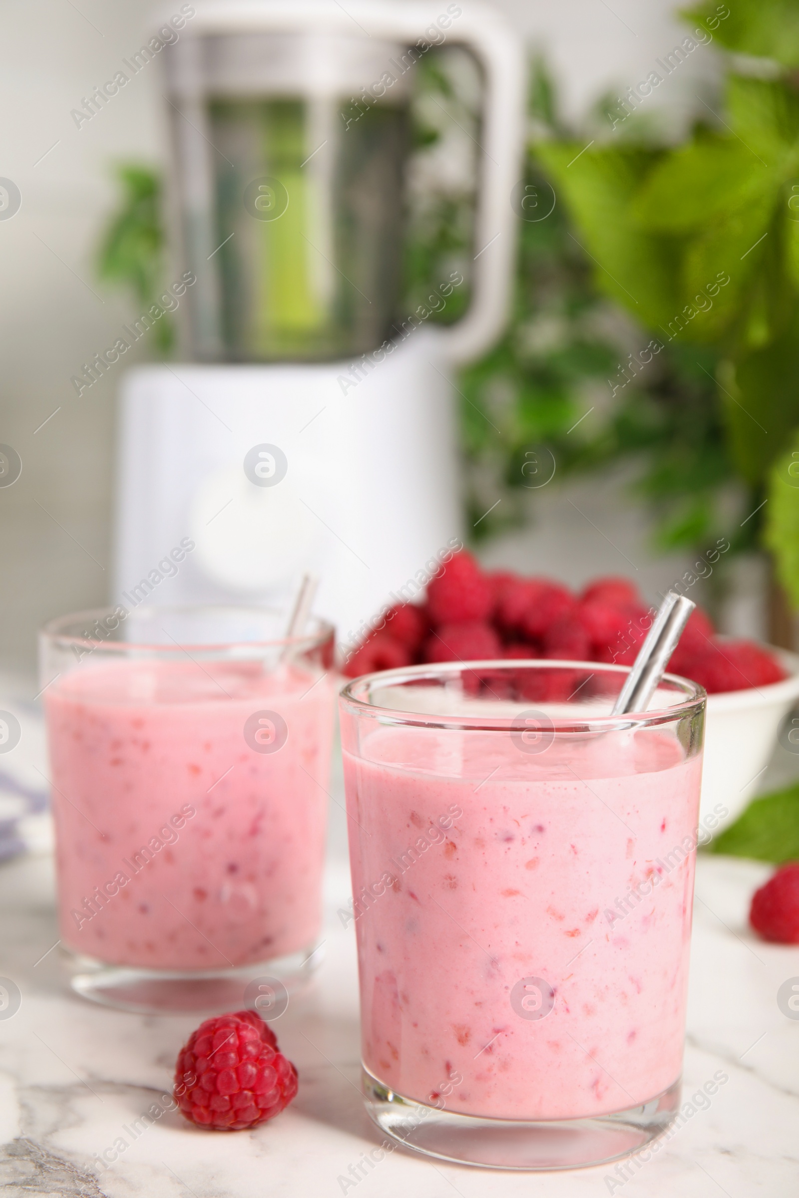 Photo of Tasty fresh raspberry smoothie on white marble table