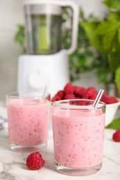 Photo of Tasty fresh raspberry smoothie on white marble table