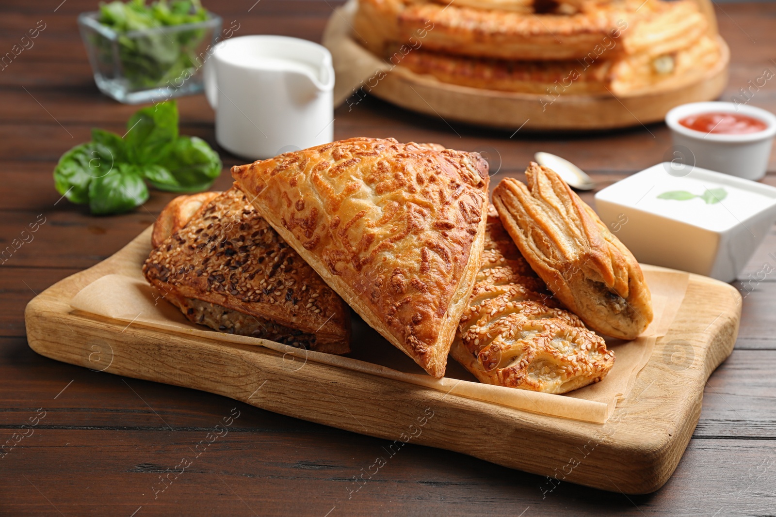 Photo of Fresh delicious puff pastry served on wooden table