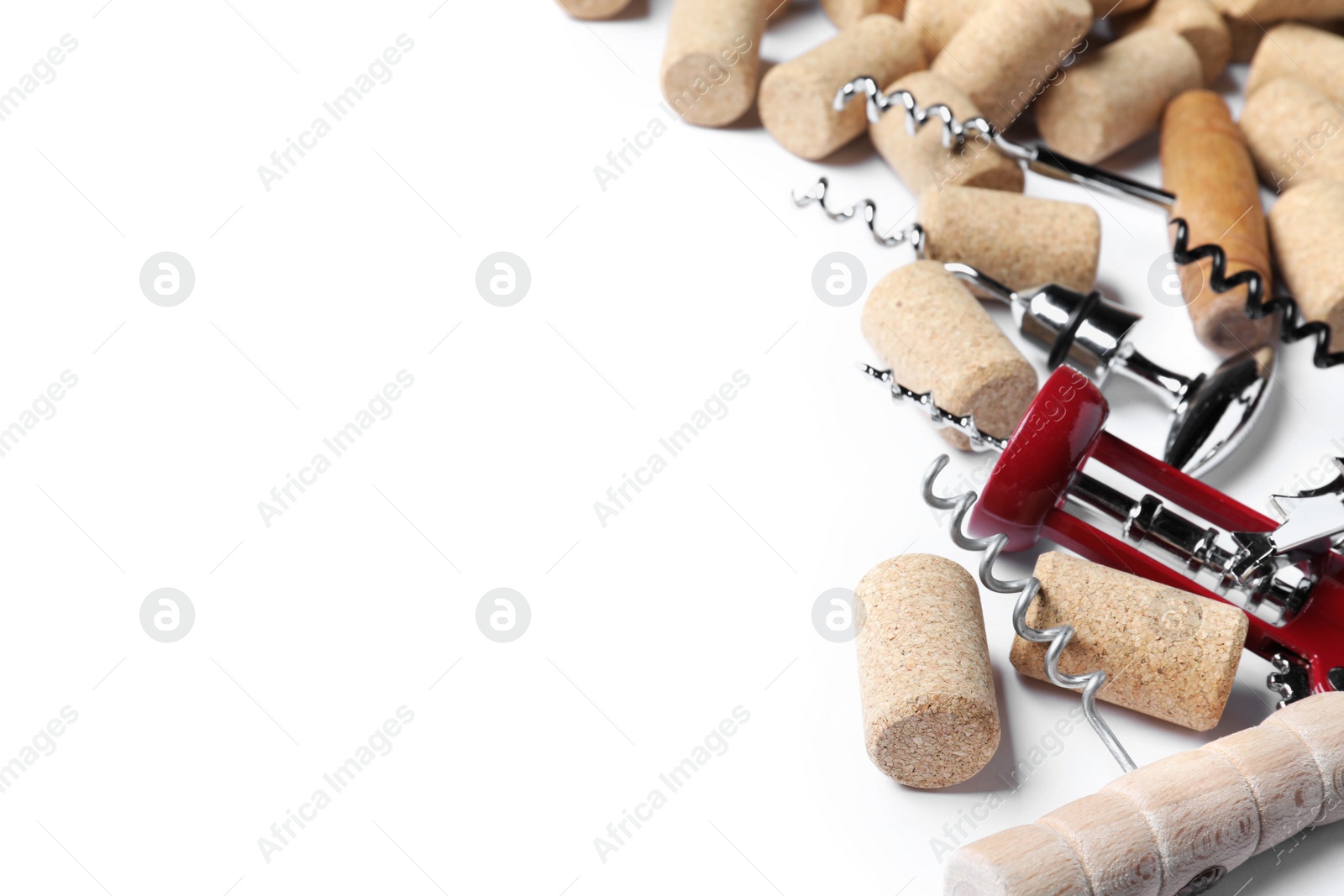 Photo of Different corkscrews and wine bottle stoppers on white background