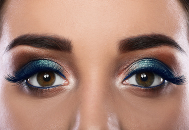 Young woman with color eyelashes and beautiful makeup, closeup