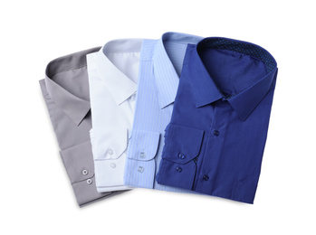 Photo of Stylish shirts isolated on white, top view. Dry-cleaning service