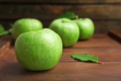 Photo of Fresh green apples on wooden background