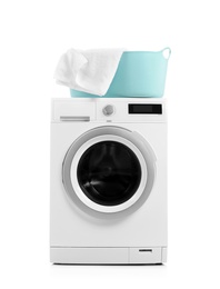 Modern washing machine and basket with laundry on white background