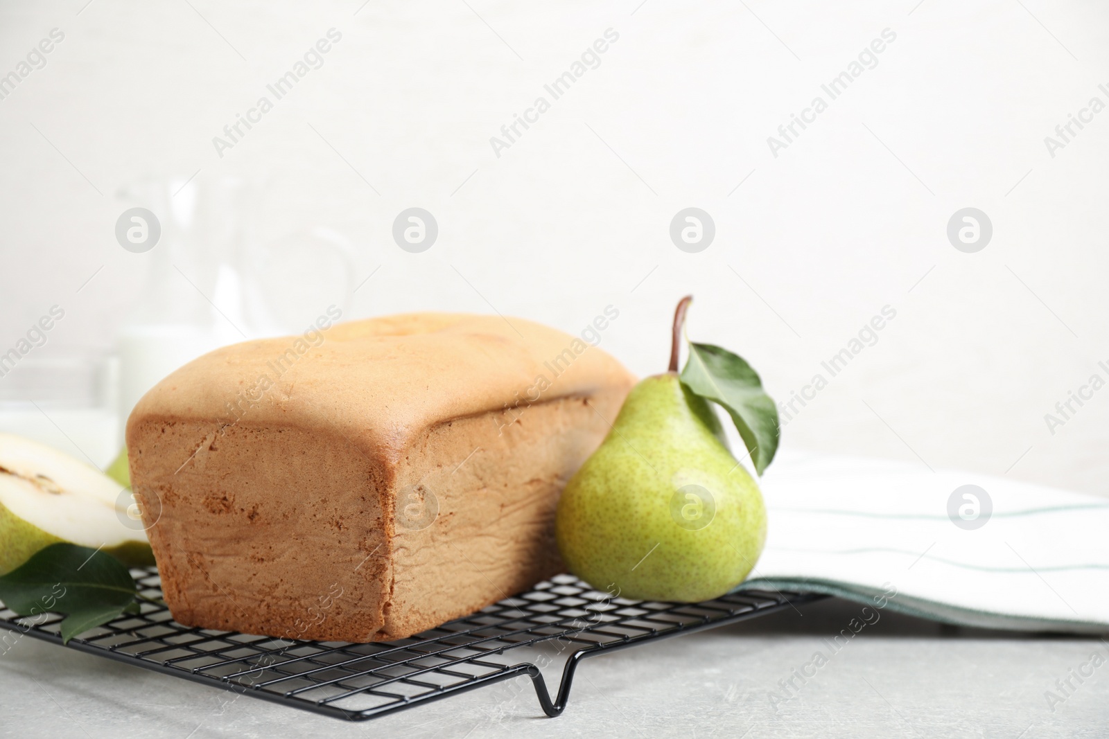Photo of Tasty bread and pears on light grey table. Homemade cake