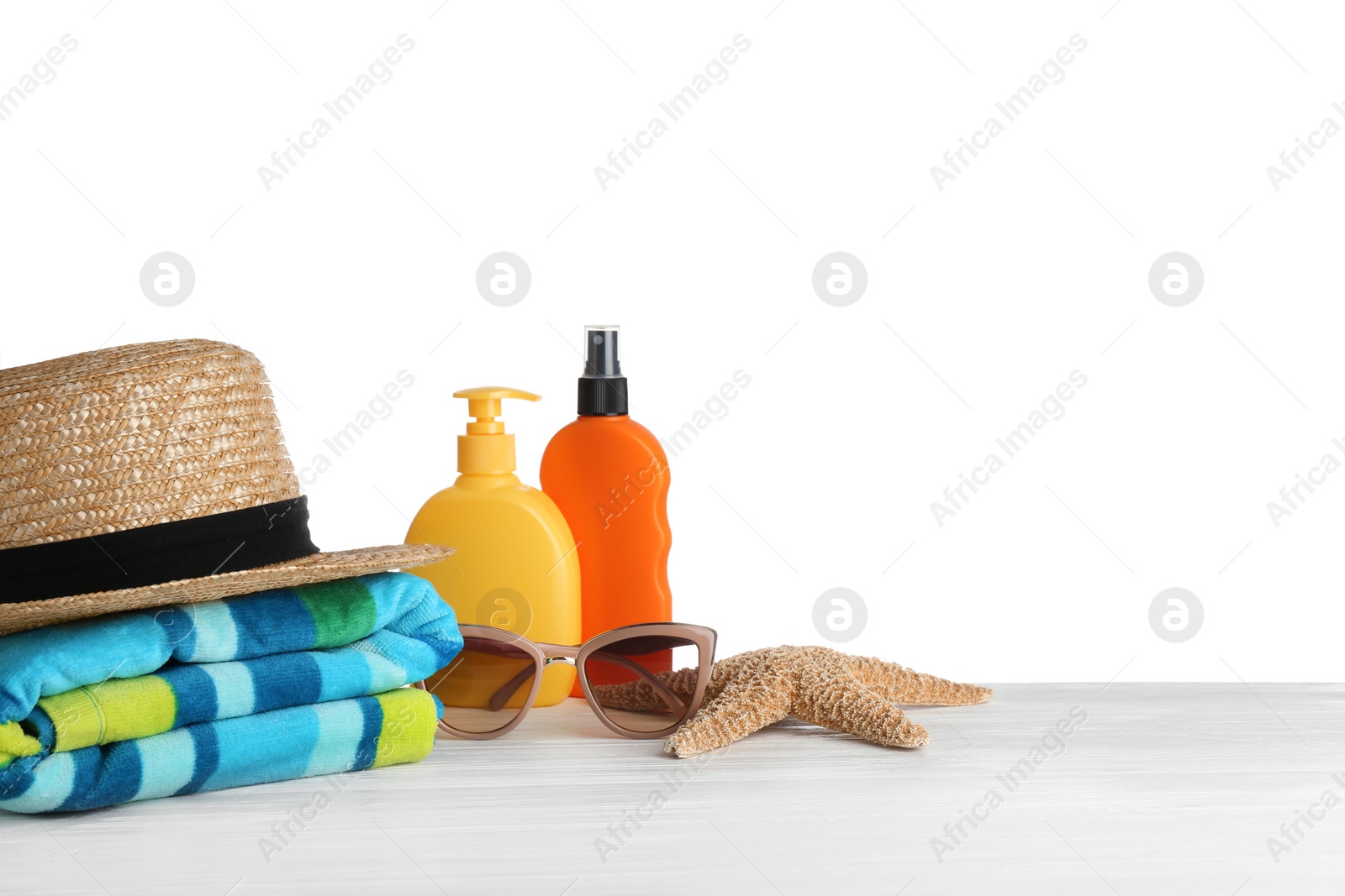 Photo of Set of beach accessories on table against white background. Space for text