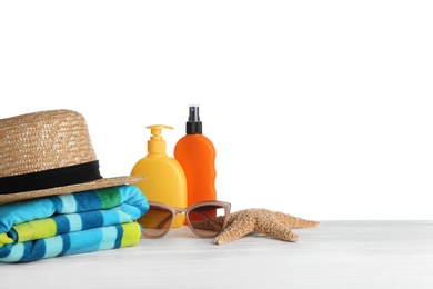 Photo of Set of beach accessories on table against white background. Space for text