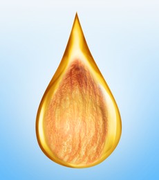 Image of Drop of organic oil with almond inside on light blue background