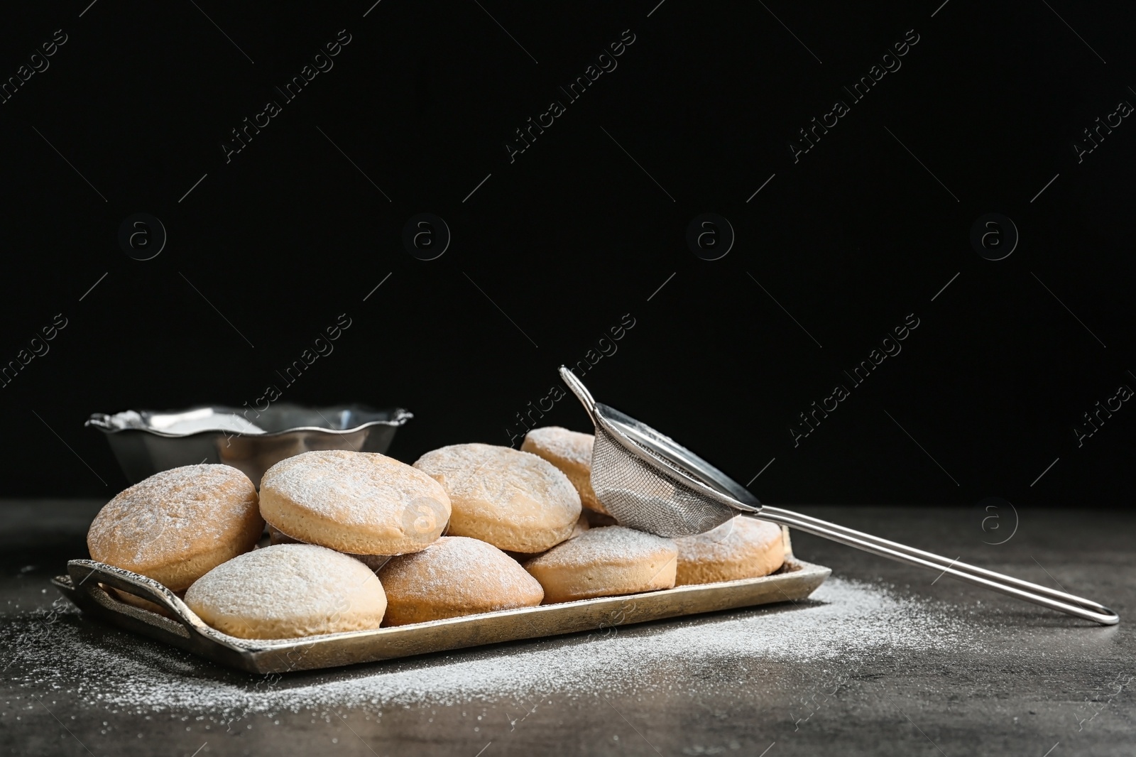 Photo of Tray of traditional cookies for Islamic holidays and strainer on table. Eid Mubarak