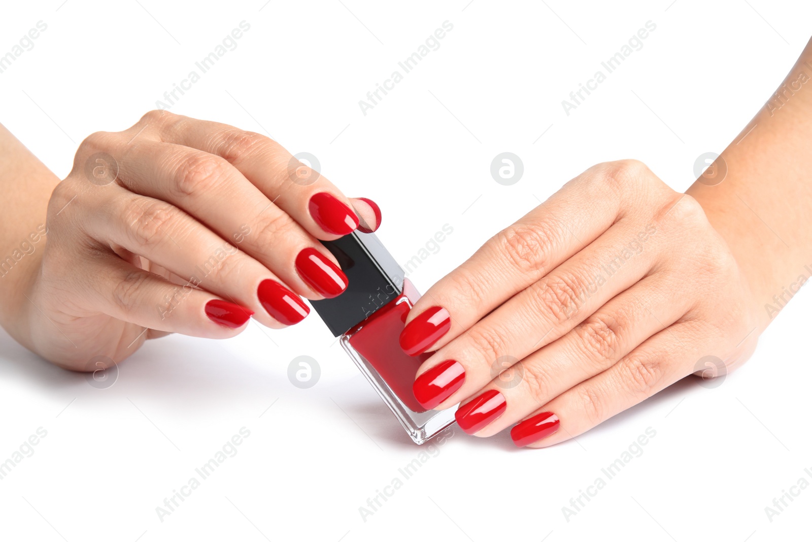 Photo of Woman with bright manicure holding bottle of nail polish on white background, closeup