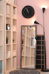 Photo of Stylish interior with large mirror and wardrobe