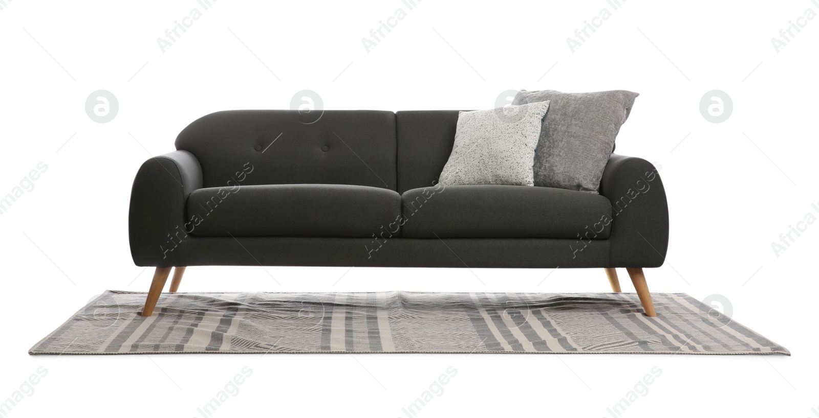 Photo of Comfortable grey sofa with cushions and carpet on white background. Furniture for living room interior