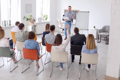 Photo of Male business trainer giving lecture in office