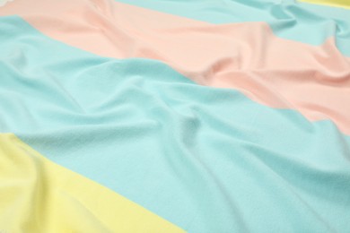 Photo of Crumpled colorful beach towel as background, closeup view