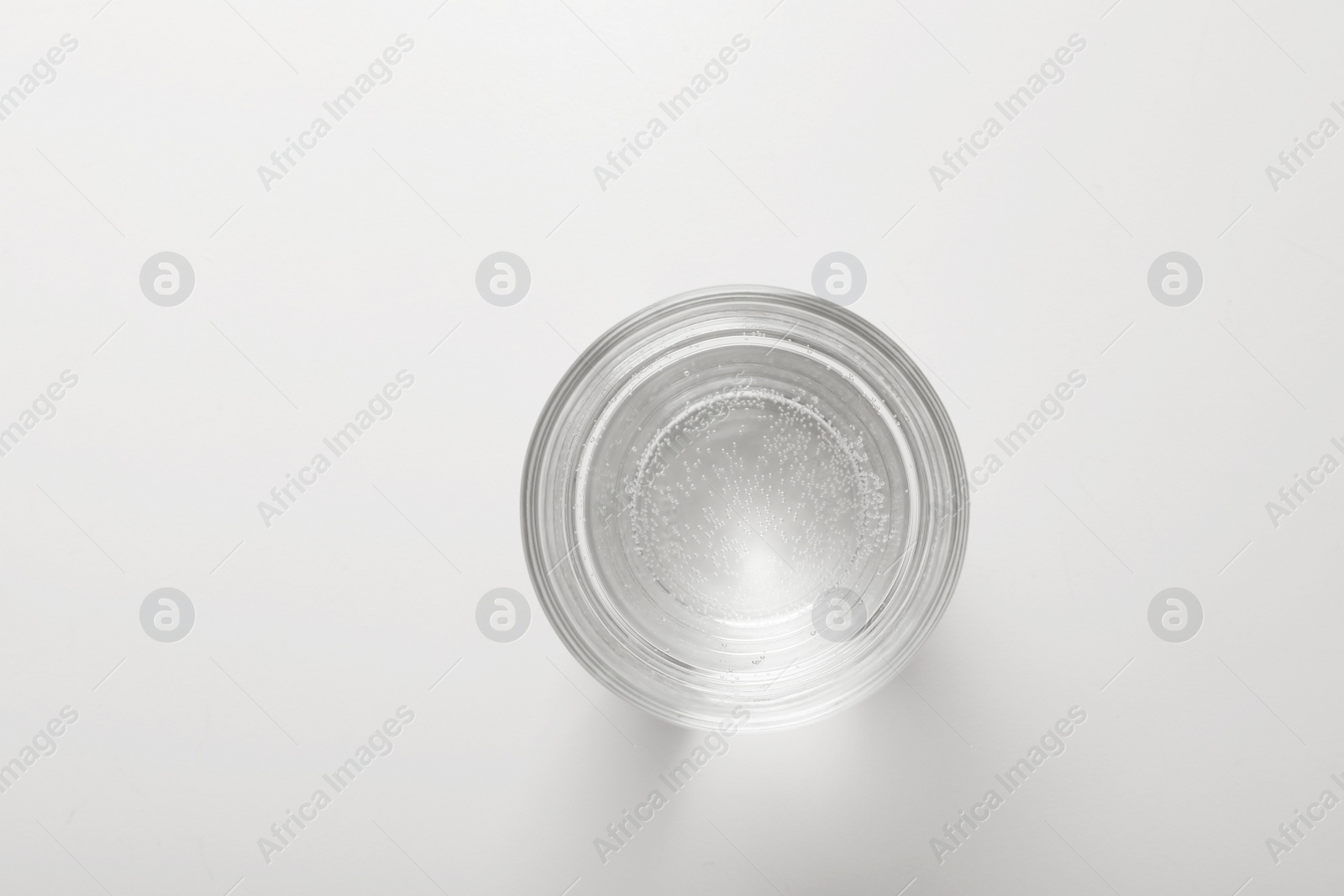 Photo of Glass of fresh water on white background, top view