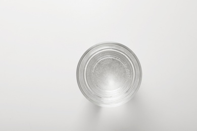 Glass of fresh water on white background, top view