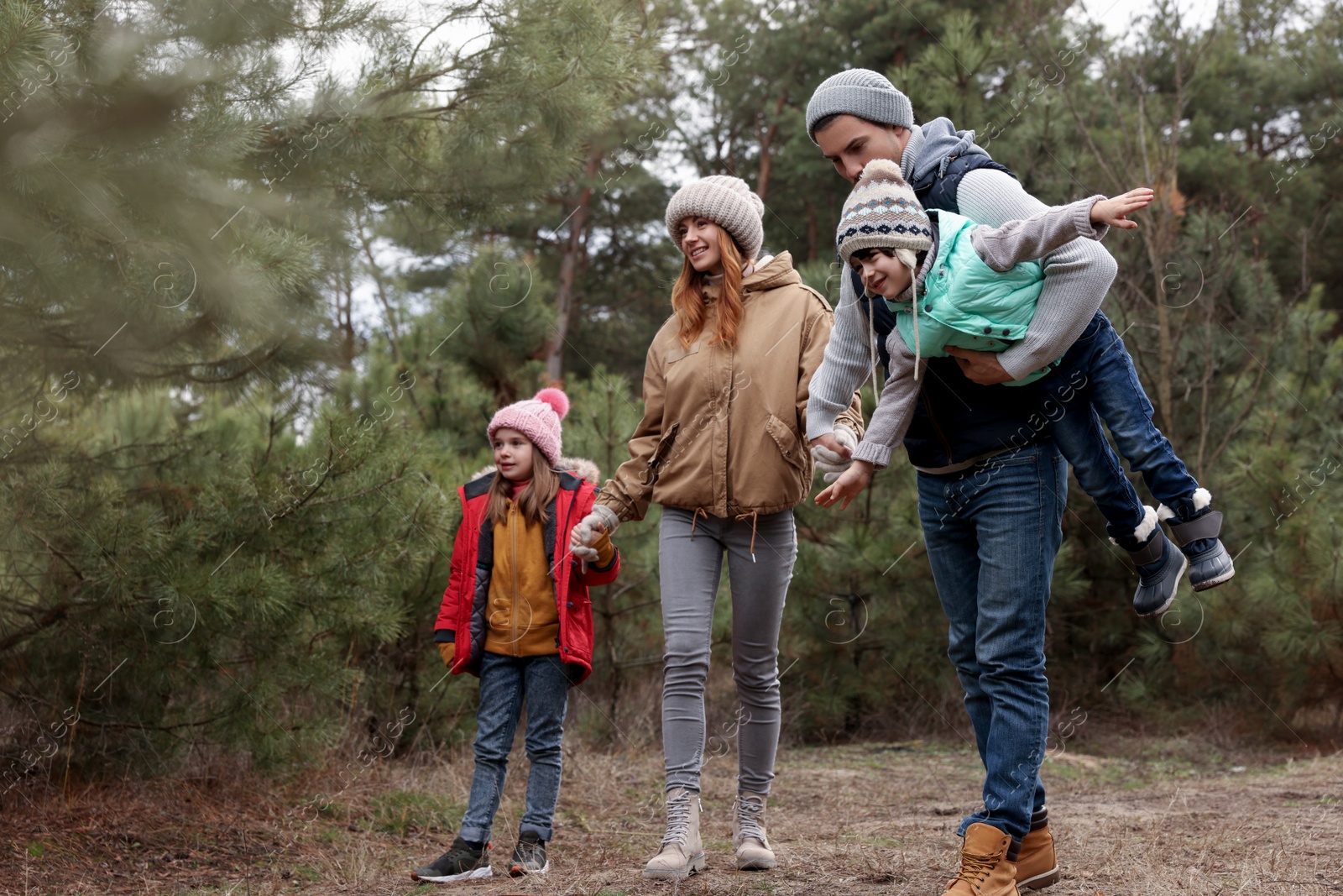 Photo of Happy family spending time together in forest