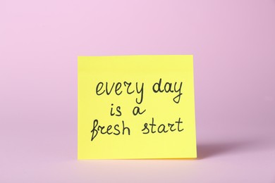 Photo of Note with phrase Every Day Is A Fresh Start on pink background. Motivational quote