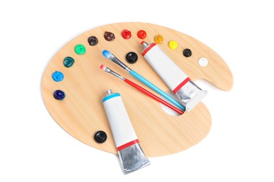 Photo of Palette with acrylic paints and brushes on white background, top view. Artist equipment