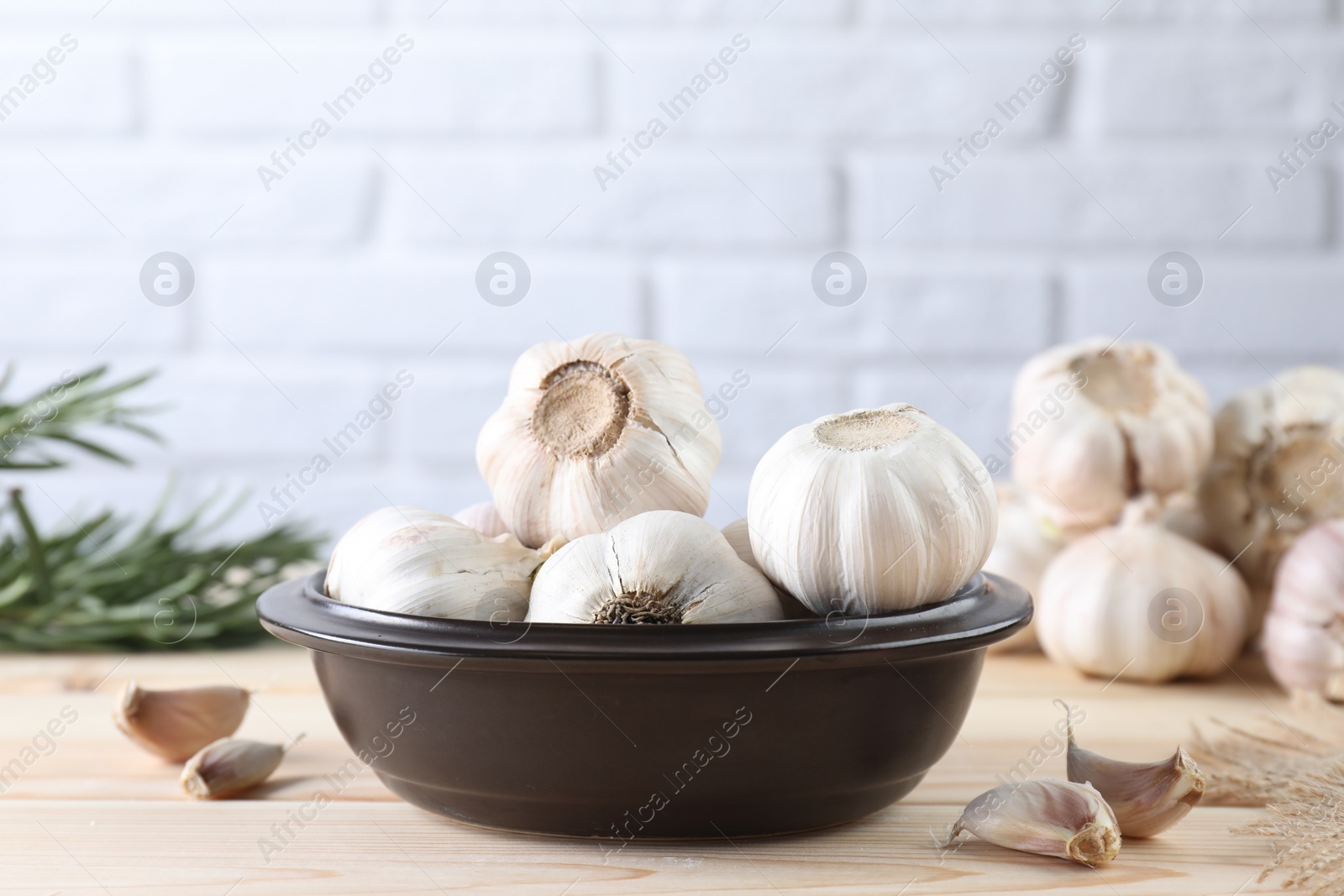 Photo of Bulbs and cloves of fresh garlic on wooden table