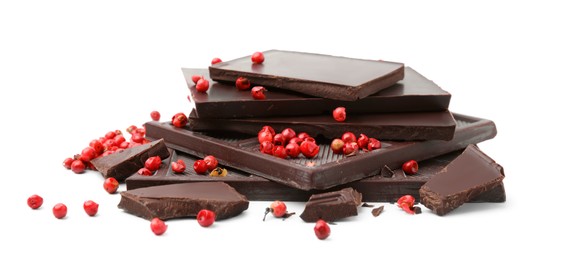 Red peppercorns and pieces of dark chocolate isolated on white