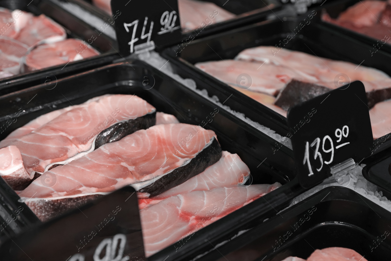 Photo of Steaks of fresh fish in supermarket, closeup