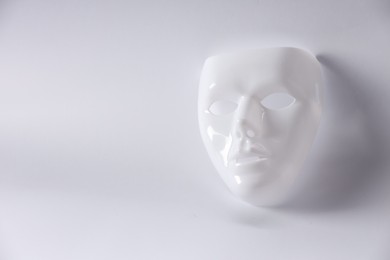 Plastic face mask on white background, space for text. Theatrical performance