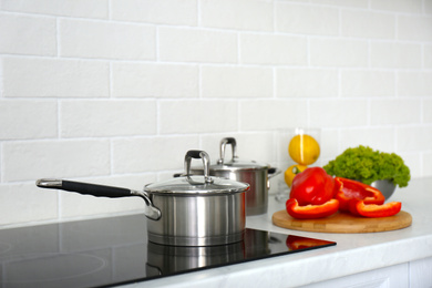 Kitchen counter with products and saucepan on stove