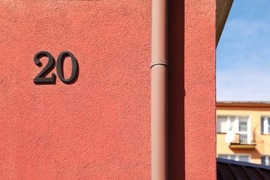 Number 20 on beautiful pink house outdoors. Space for text