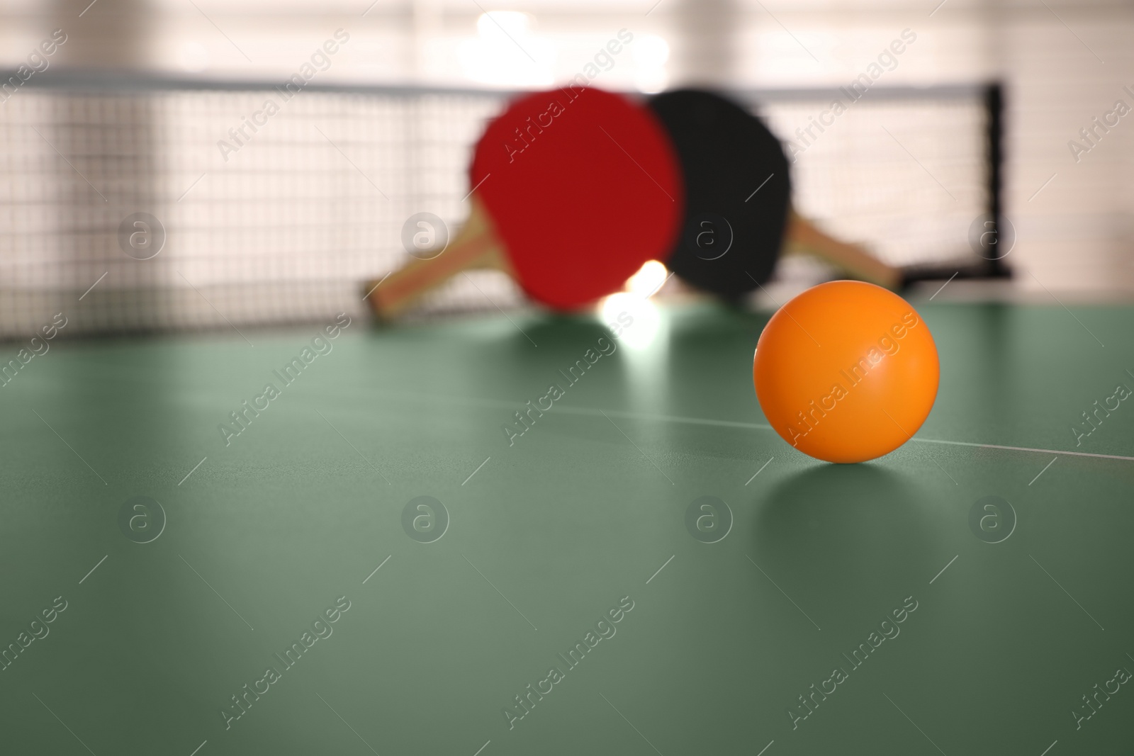 Photo of Yellow ball on ping pong table, space for text