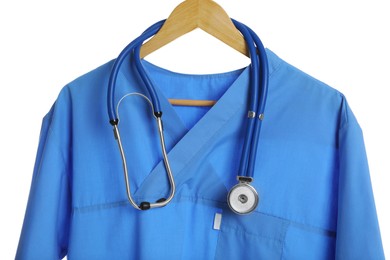 Photo of Light blue medical uniform and stethoscope on white background