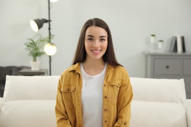 Photo of Portrait of happy young woman in room