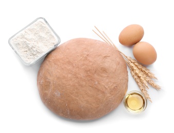 Raw rye dough and ingredients on white background, top view