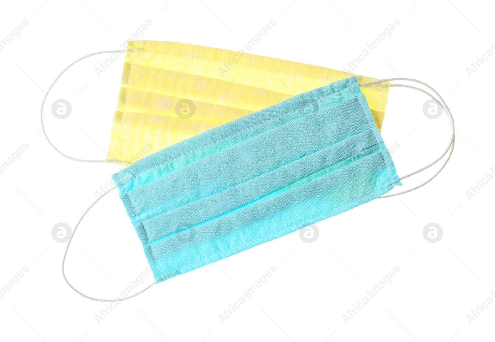 Photo of Homemade protective face masks isolated on white, top view