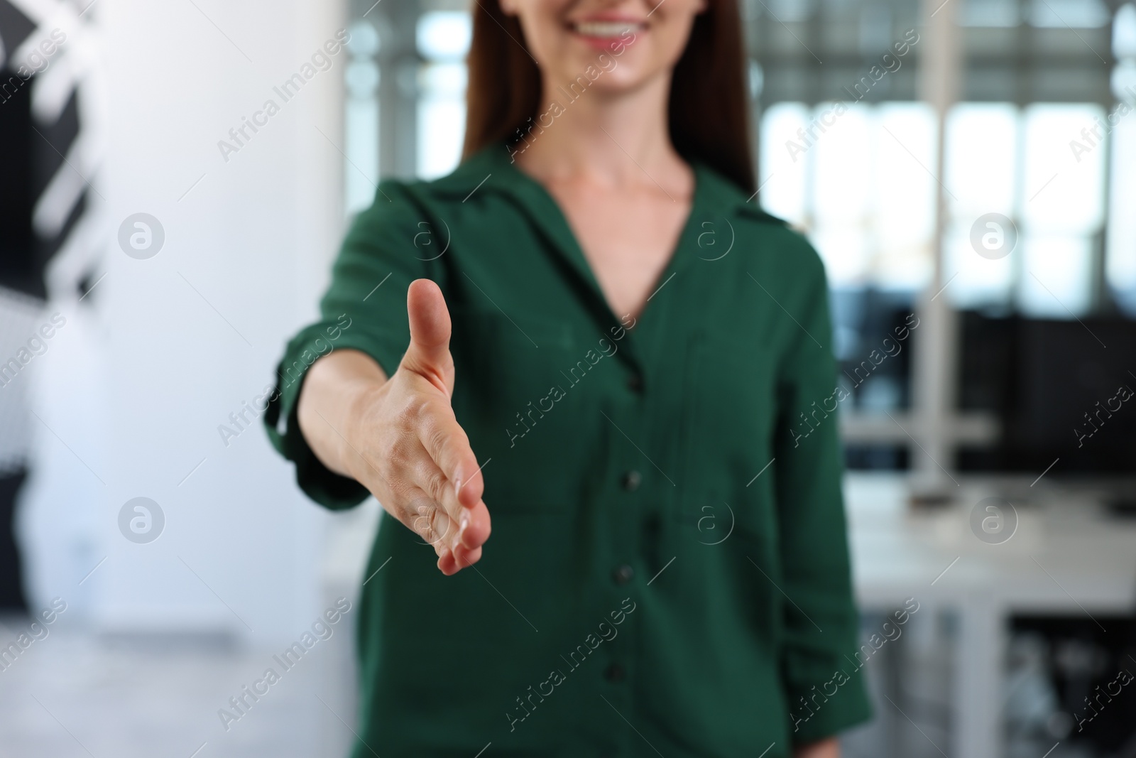 Photo of Woman welcoming and offering handshake in office, closeup