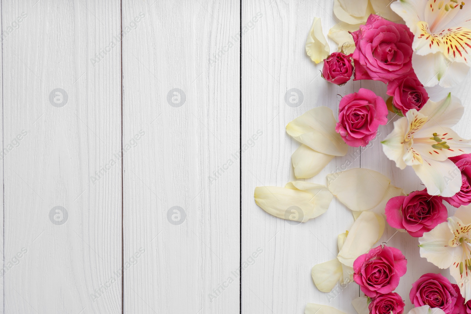 Photo of Fresh flowers on wooden background, top view with space for text