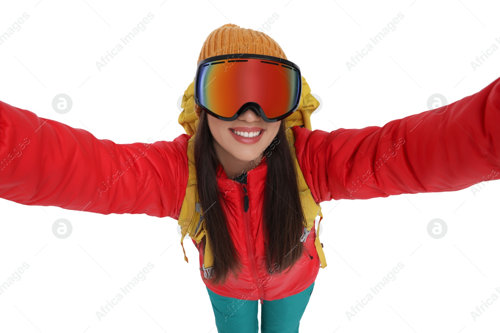 Photo of Smiling woman in ski goggles taking selfie on white background